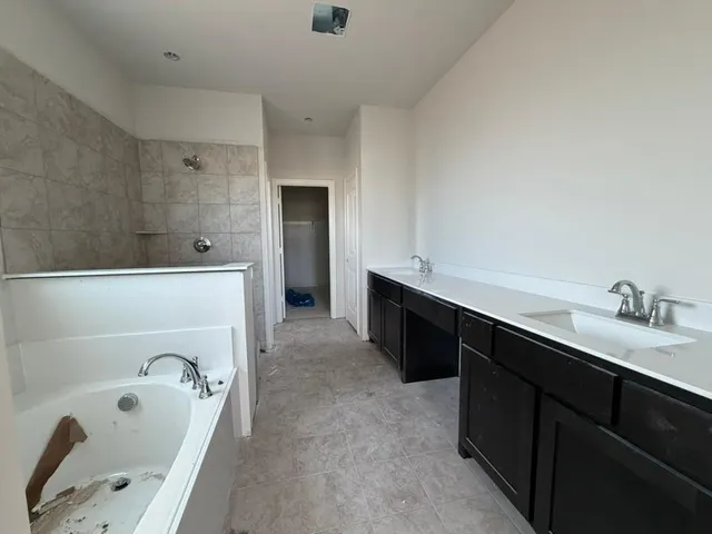 an empty room with staircase and mirror