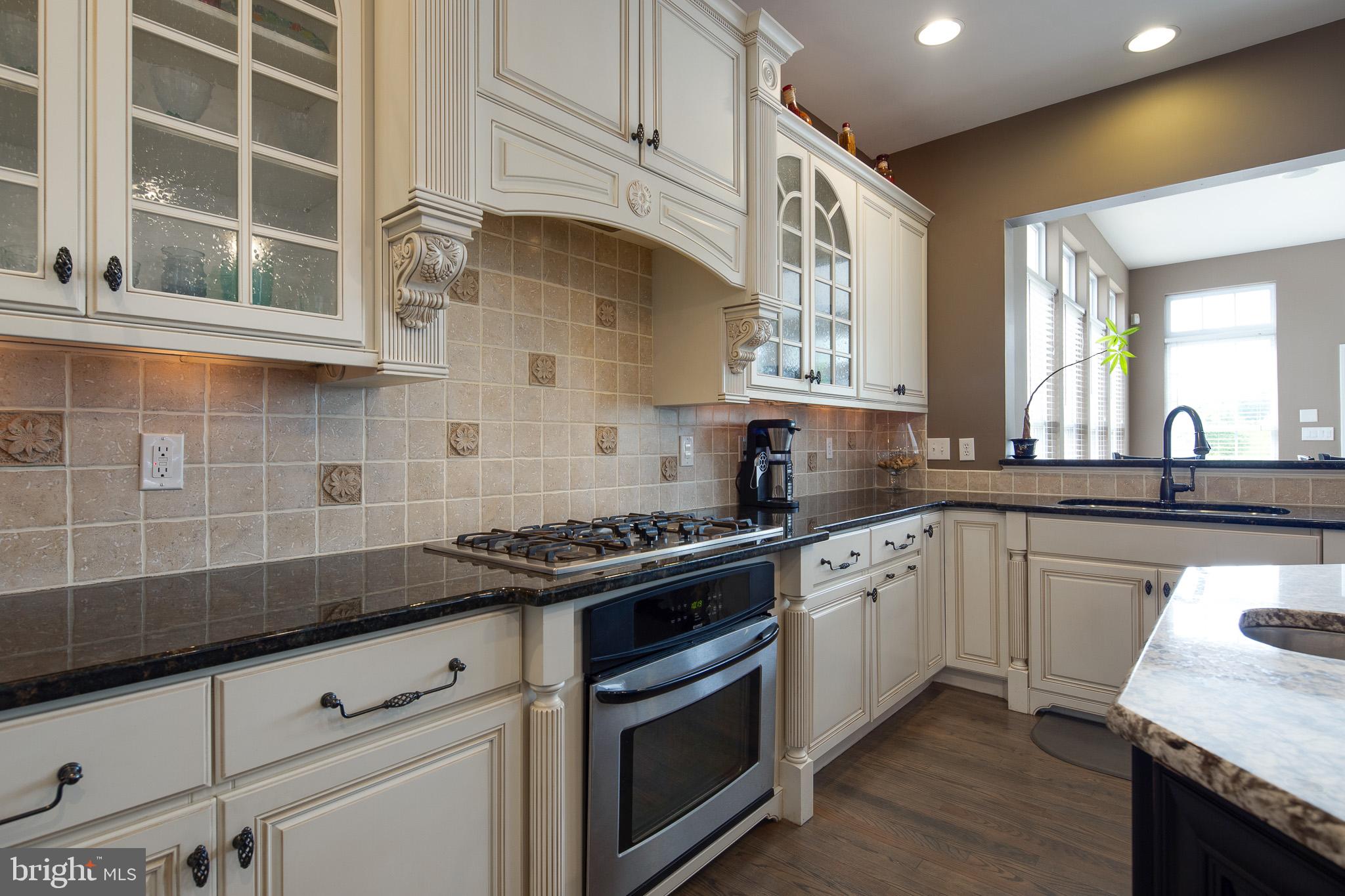 440 Spring Hollow Drive Middletown, DE 19709 - Photo 14 of 64 a kitchen with stainless steel appliances granite countertop a sink stove and cabinets