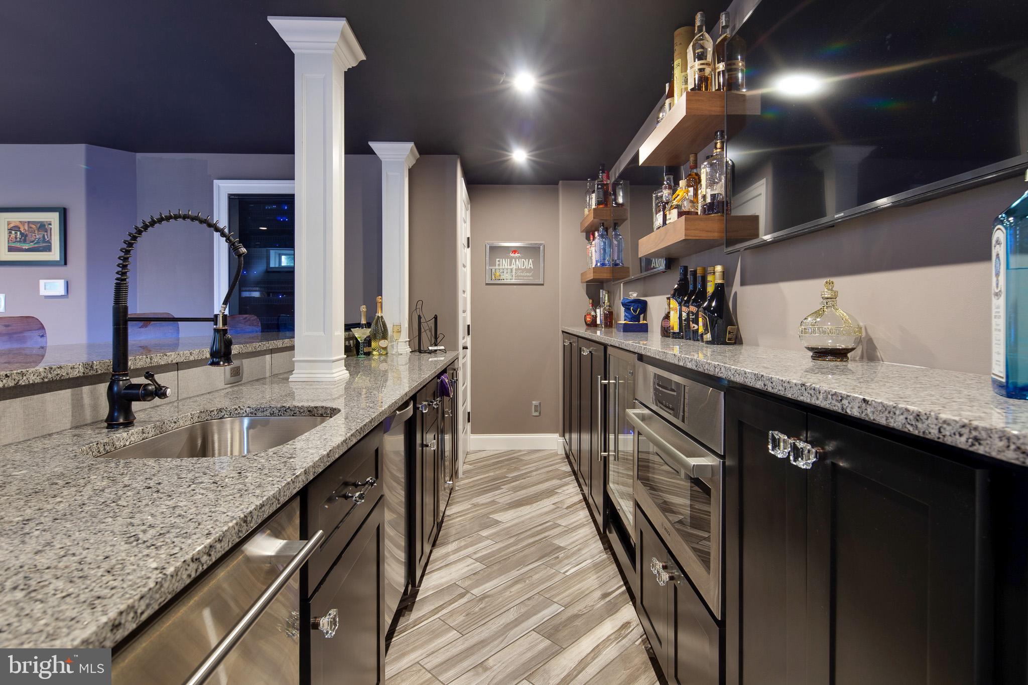 440 Spring Hollow Drive Middletown, DE 19709 - Photo 40 of 64 a kitchen with stainless steel appliances granite countertop sink stove and cabinets