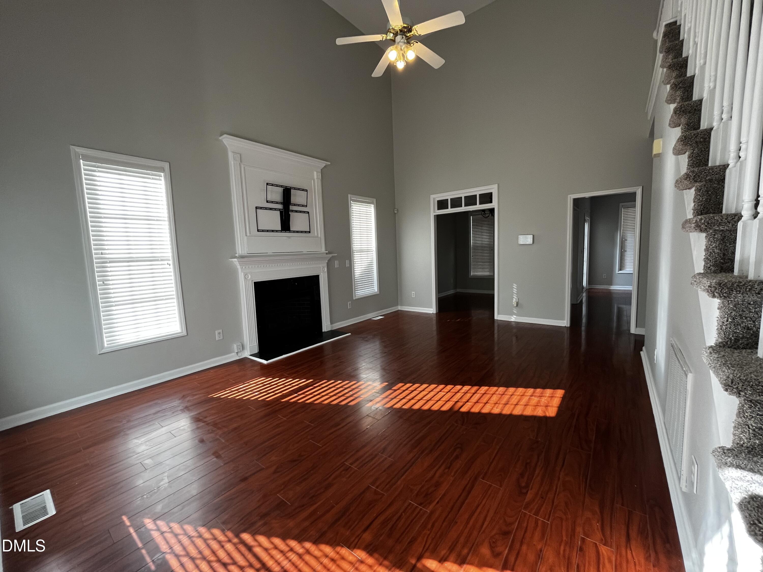 2816 Rainford Court Raleigh, NC 27603 - Photo 2 of 17 wooden floor in an empty room with a fireplace