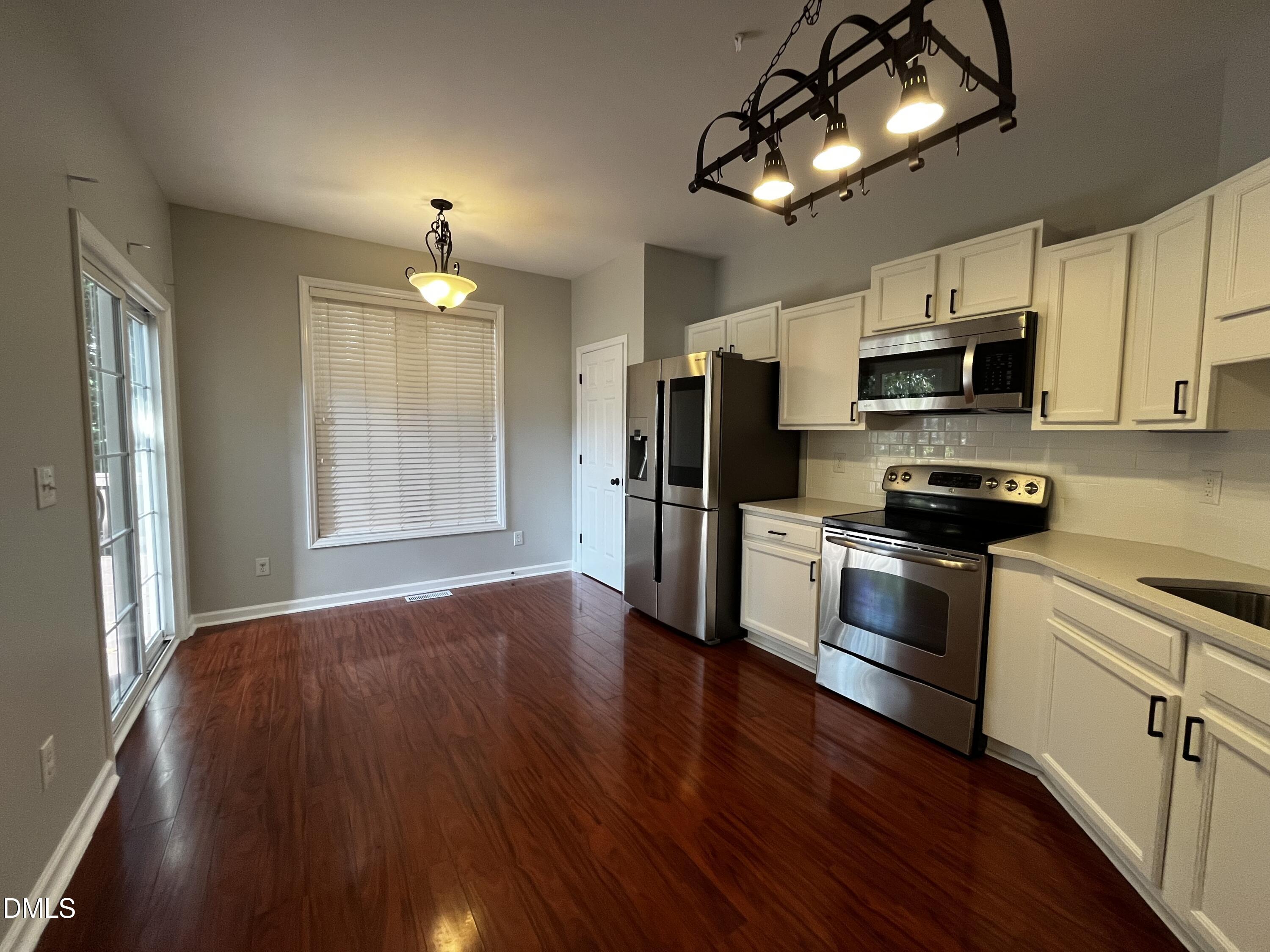 2816 Rainford Court Raleigh, NC 27603 - Photo 4 of 17 a kitchen with stainless steel appliances a stove a refrigerator and microwave