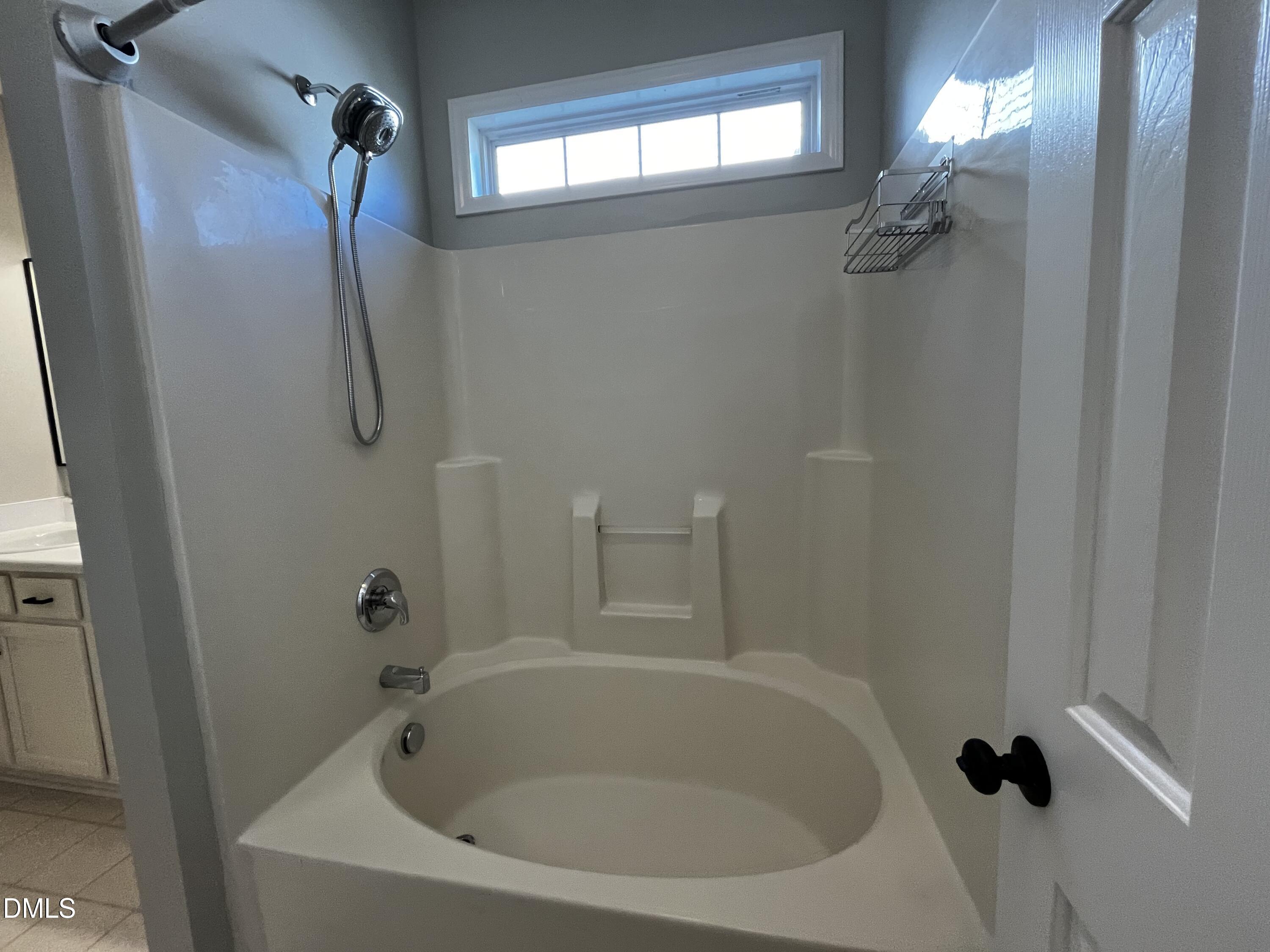 2816 Rainford Court Raleigh, NC 27603 - Photo 10 of 17 a white bath tub sitting next to a shower