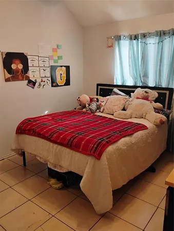 a bed sitting in a bedroom next to a window