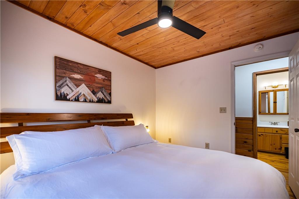 357 Mystic Lane Blue Ridge, GA 30513 - Photo 20 of 58 a bedroom with a bed and a painting on the wall