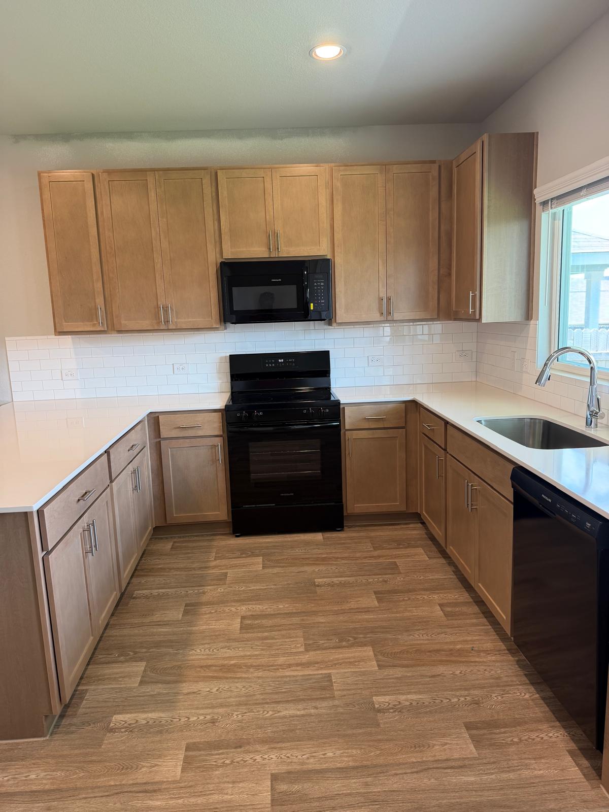 2701 Towy Road Manor, TX 78653 - Photo 19 of 35 A well-equipped kitchen features ample cabinetry, durable flooring, and essential appliances, ready for culinary endeavors.