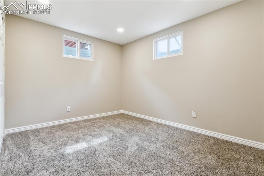 114 Chelton Road Colorado Springs, CO 80910 - Photo 15 of 18 Basement bedroom 2 with new LED lighting and new carpet
