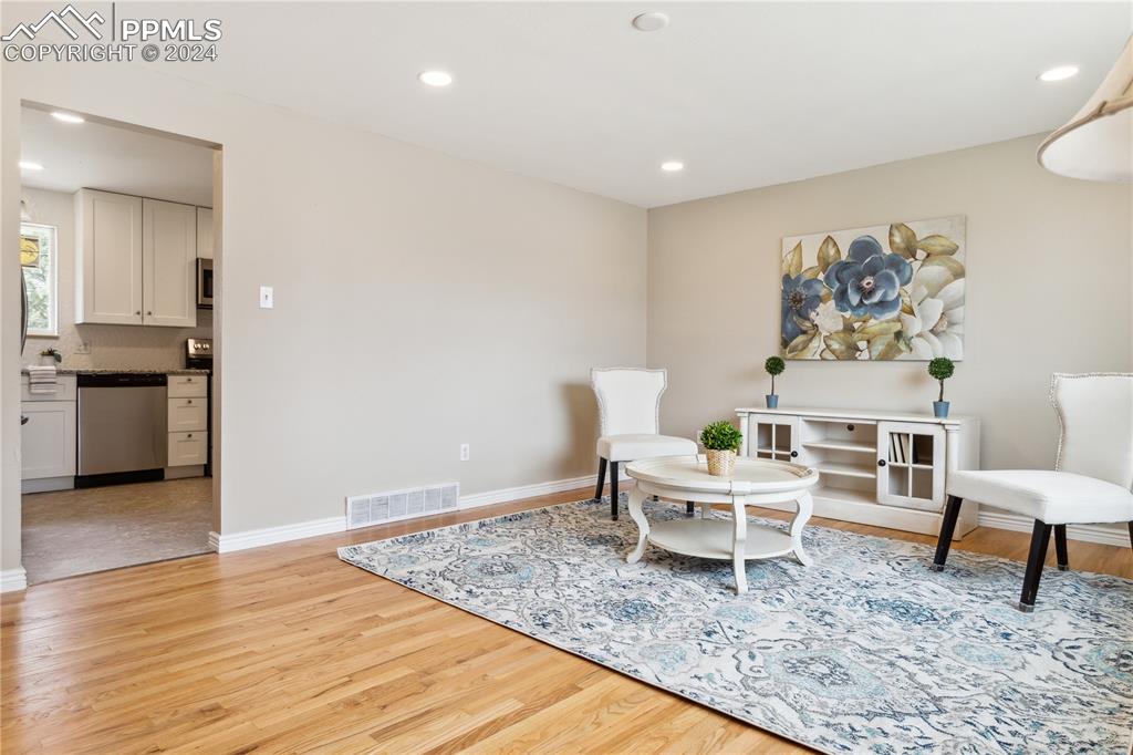 114 Chelton Road Colorado Springs, CO 80910 - Photo 5 of 18 Living area with refinished wood floors