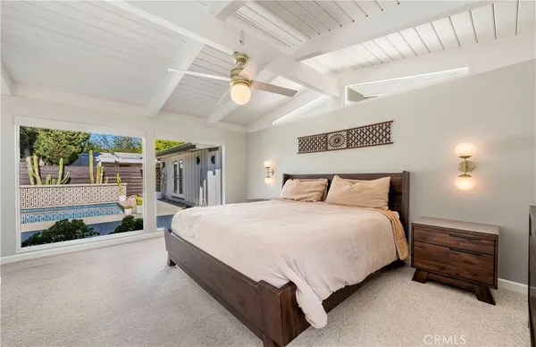 a large bed sitting in a room next to a lamp