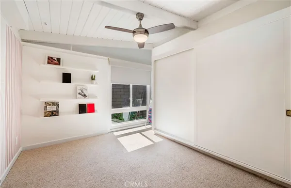 an white cabinet with windows and ceiling fan