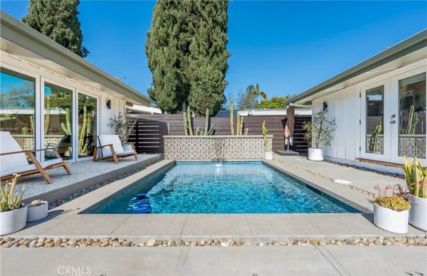 swimming pool view with a outdoor seating