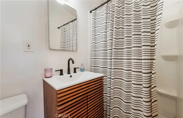 a bathroom with a sink a toilet and mirror
