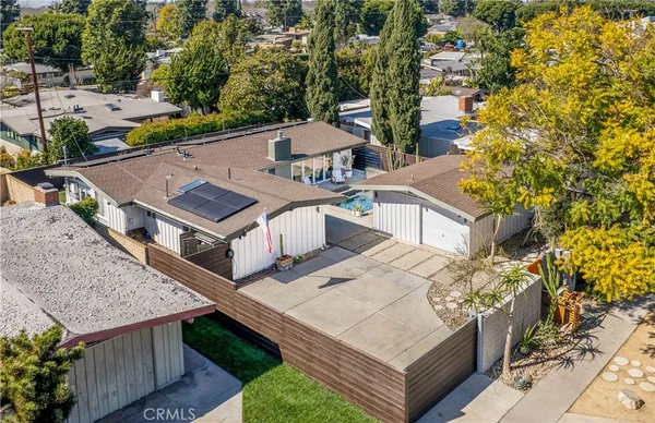 an aerial view of a house with a yard