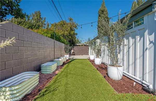 a view of a backyard with sitting area