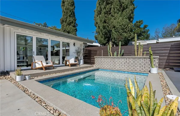 swimming pool view with a outdoor seating space