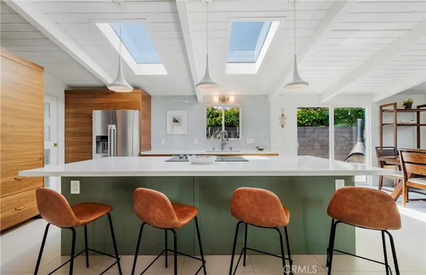 a dining room with chairs and window