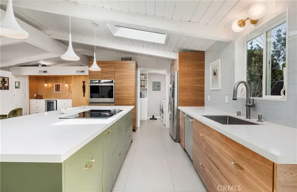 a kitchen with stainless steel appliances a sink stove and cabinets