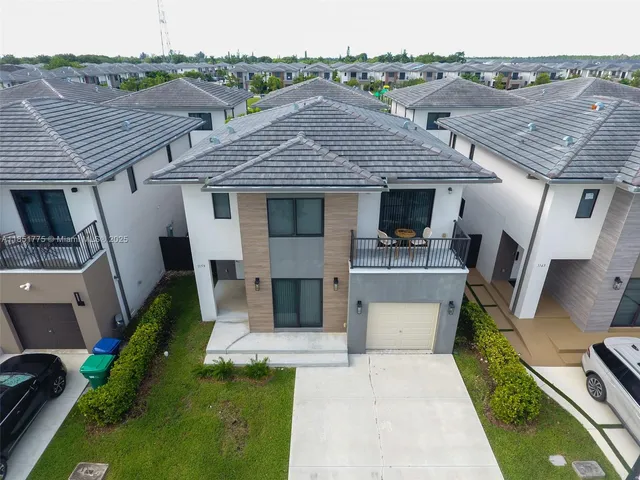 an aerial view of a house with a yard