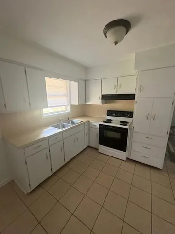 a kitchen with cabinets a sink and appliances