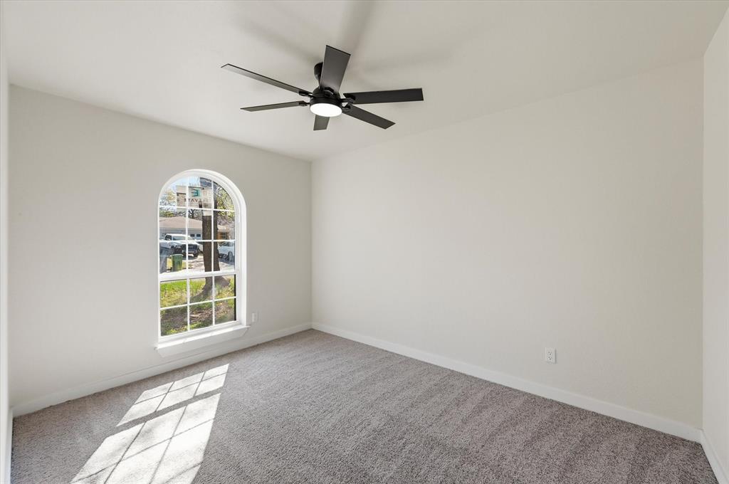 2804 Bent Tree Lane Arlington, TX 76016 - Photo 27 of 32 an empty room with windows and fan