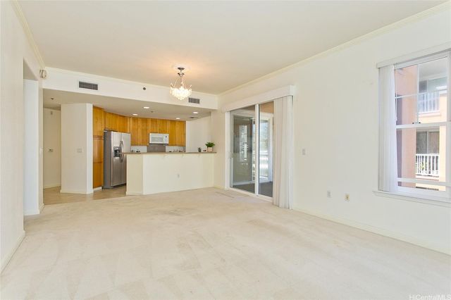a view of a kitchen with a refrigerator a sink and a window