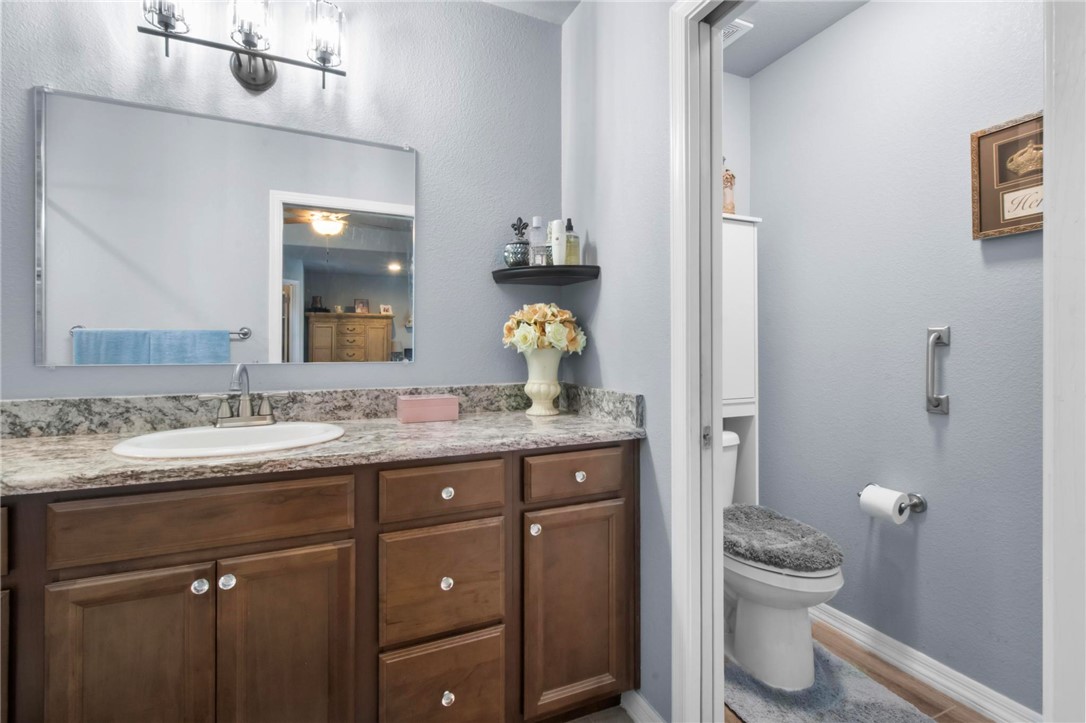 3897 Easy Street Kingman, AZ 86409 - Photo 23 of 53 a bathroom with a granite countertop toilet sink and mirror