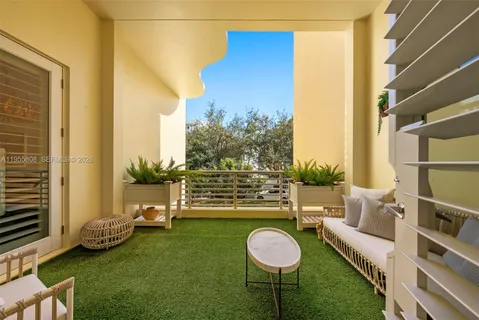 a view of a chair and table in backyard of the house