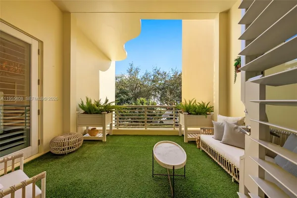 a view of a chair and table in backyard of the house