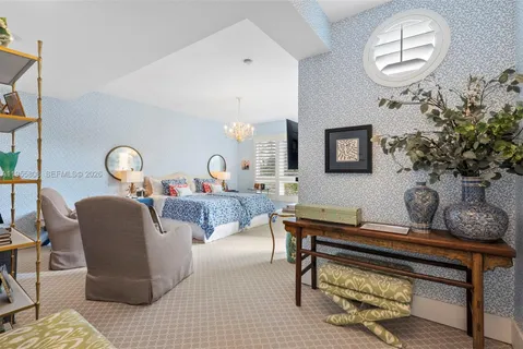 a living room with furniture and a mirror