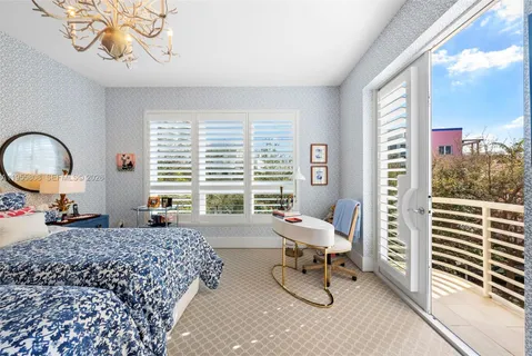 a living room with furniture a window and a chandelier