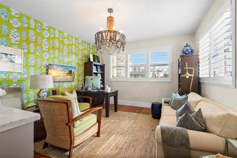 a living room with furniture a chandelier and a dining table