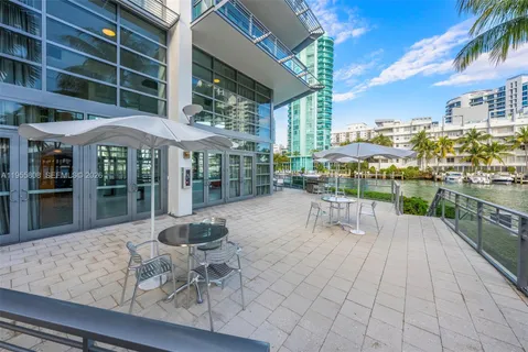 a building outdoor space with patio furniture and potted plants