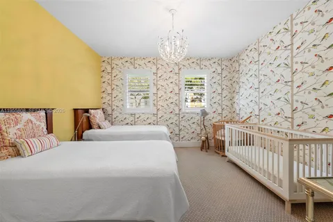 a bedroom with bed and a chandelier