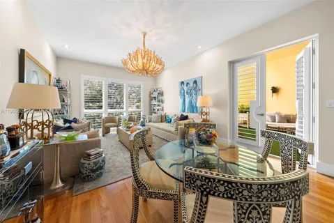 a view of a dining room with furniture a chandelier and wooden floor
