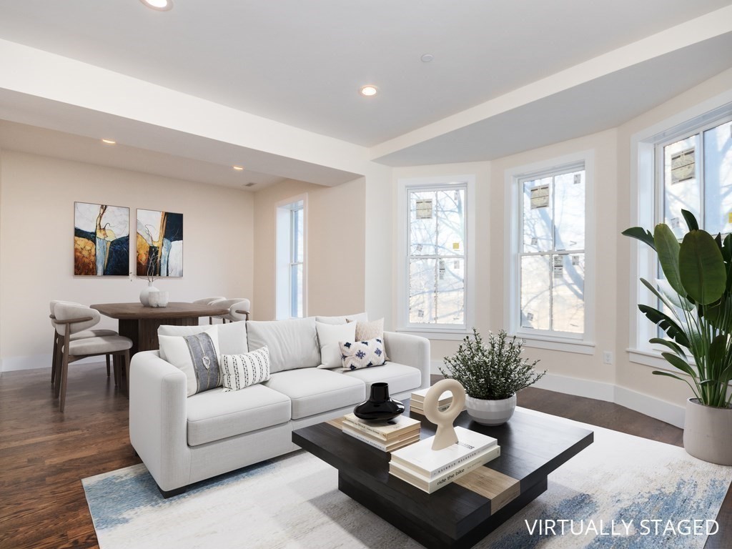 9 Monument Square, Unit 3 Boston, MA 02129 - Photo 1 of 14 a living room with furniture potted plant kitchen view and a potted plant