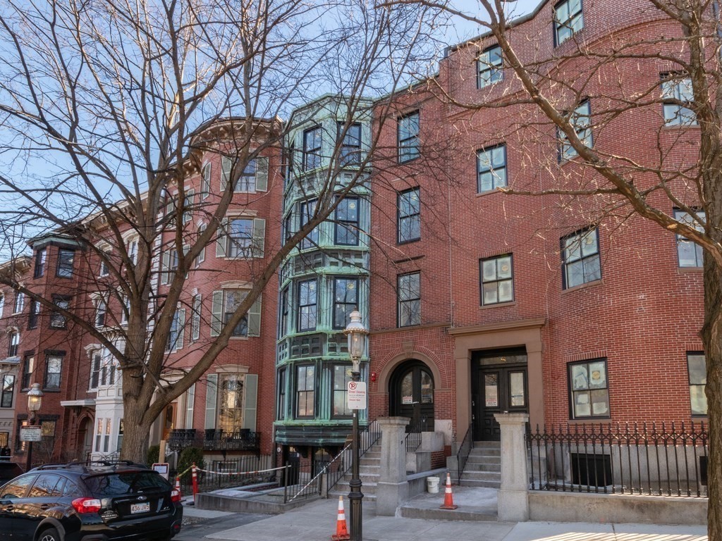9 Monument Square, Unit 3 Boston, MA 02129 - Photo 11 of 14 a front view of a building with parking area