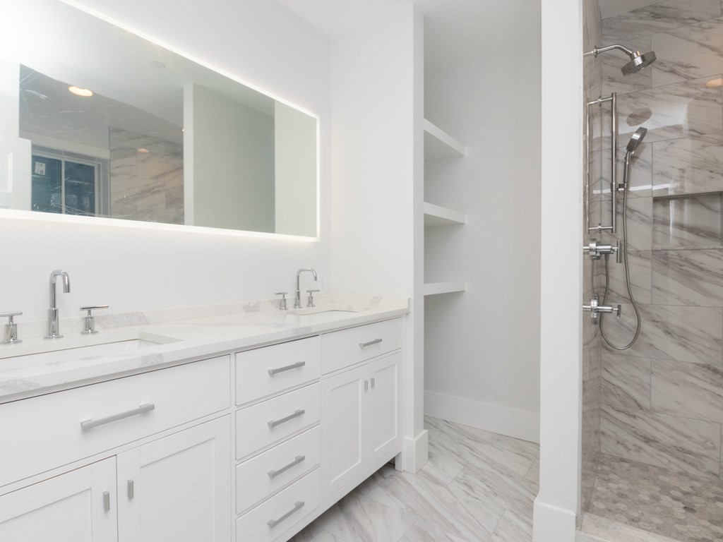 9 Monument Square, Unit 3 Boston, MA 02129 - Photo 8 of 14 a bathroom with a double vanity sink and a mirror