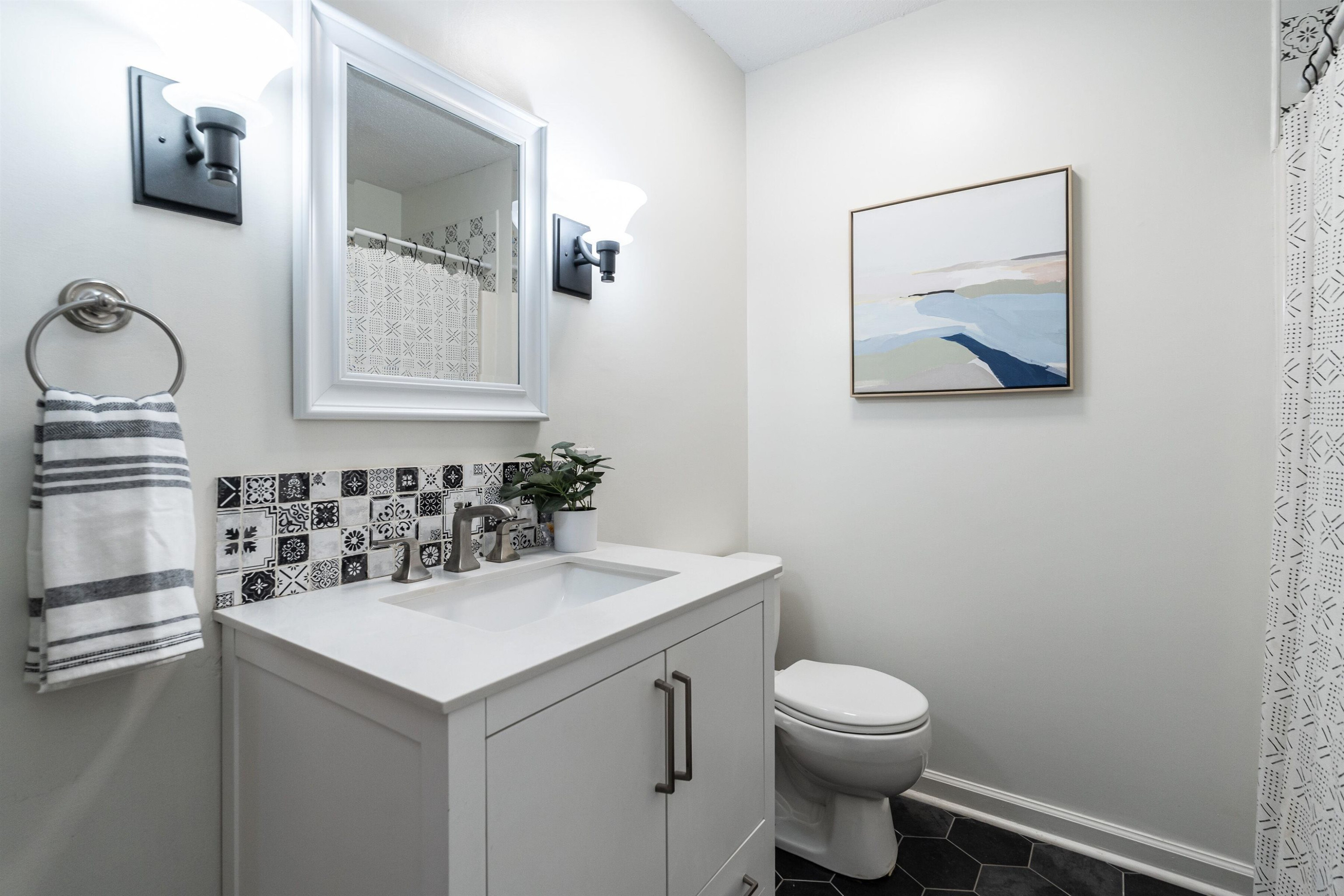 4305 Old Colony Road Raleigh, NC 27613 - Photo 20 of 33 a bathroom with a toilet sink and mirror