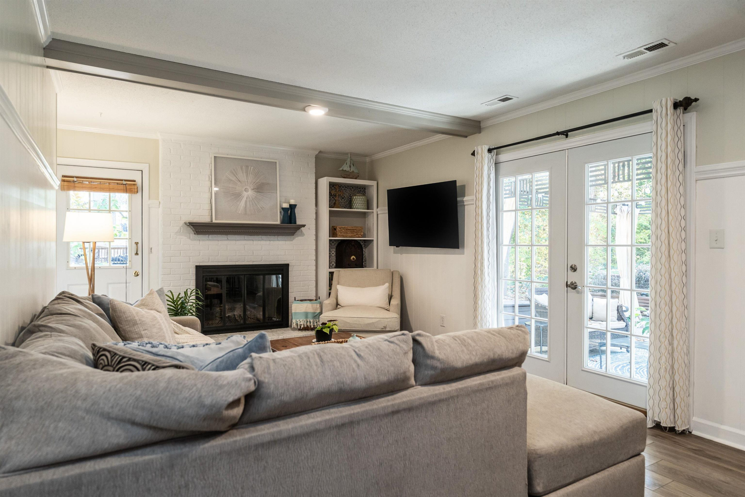 4305 Old Colony Road Raleigh, NC 27613 - Photo 22 of 33 a living room with furniture a flat screen tv and a fireplace