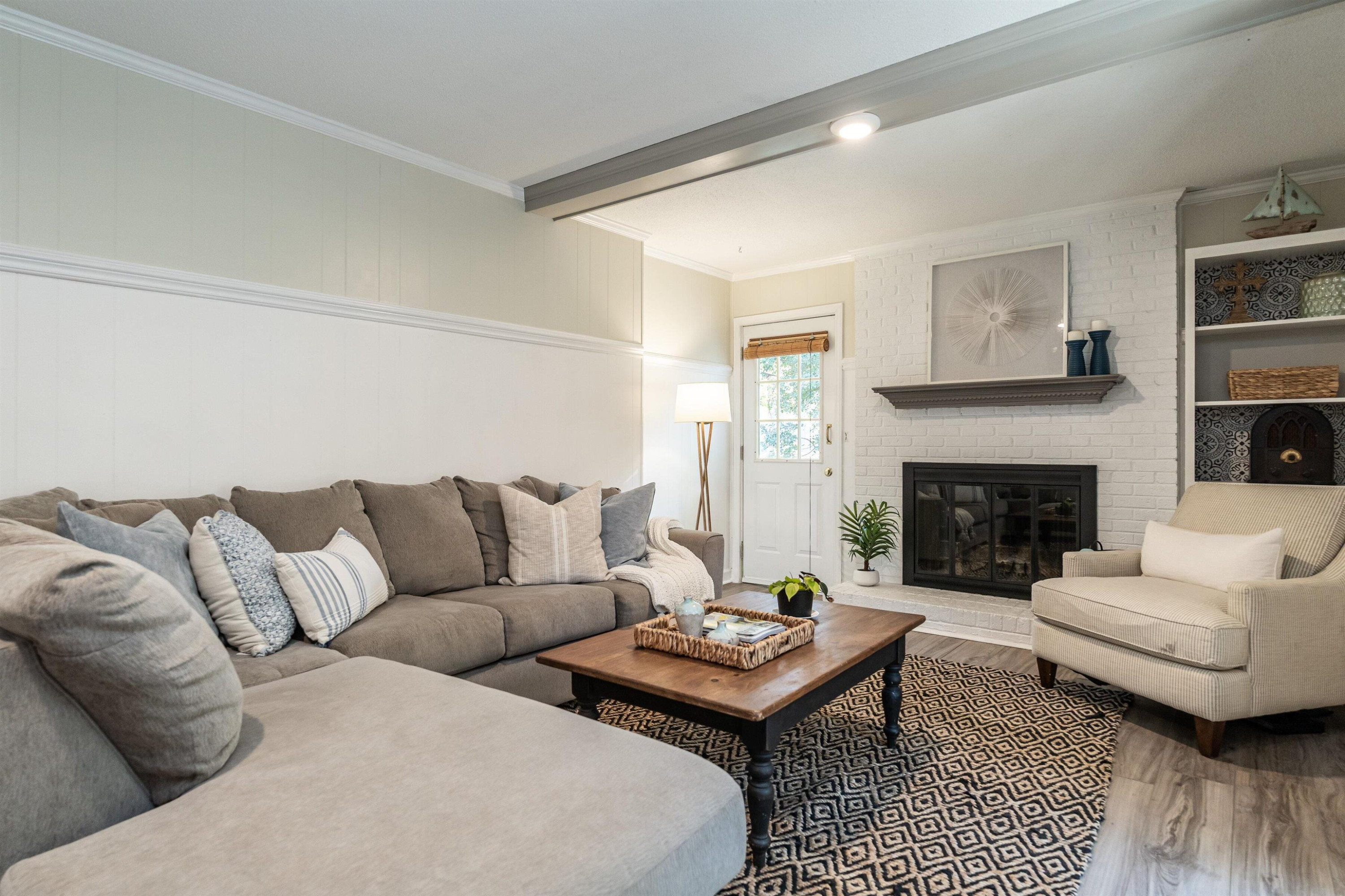 4305 Old Colony Road Raleigh, NC 27613 - Photo 23 of 33 a living room with furniture and a fireplace