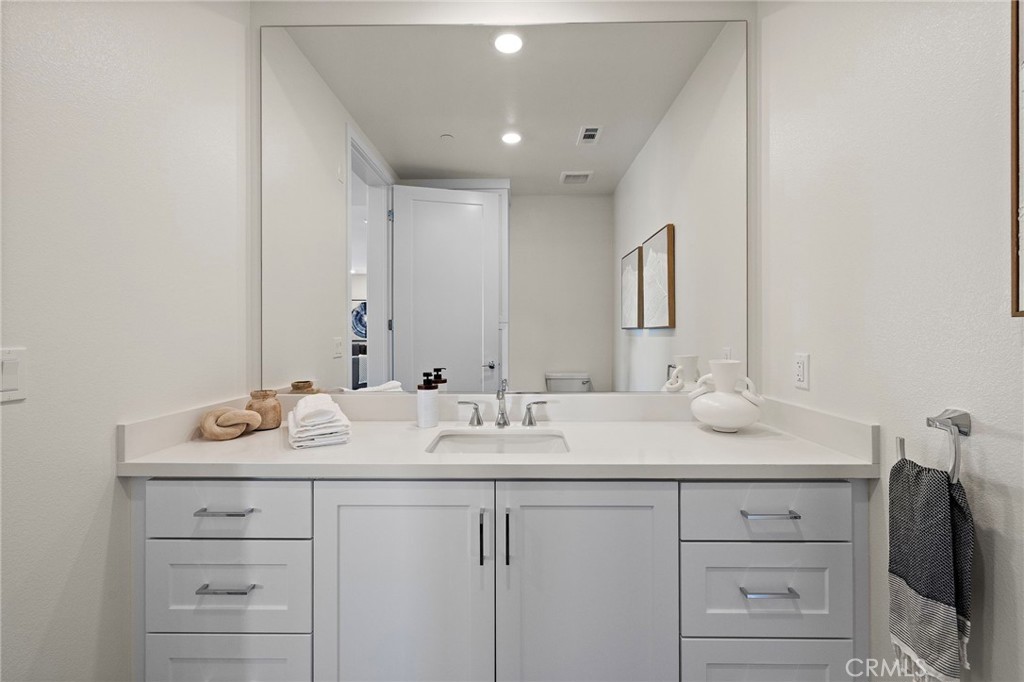 1500 Rivington Irvine, CA 92612 - Photo 13 of 37 a bathroom with a sink vanity and mirror
