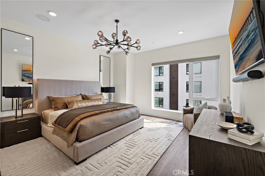 1500 Rivington Irvine, CA 92612 - Photo 18 of 37 a bedroom with a large bed and a chandelier