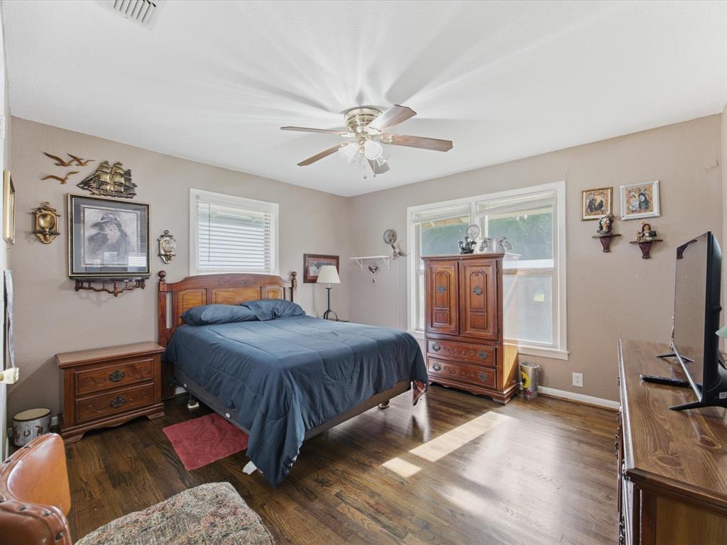301 Ovilla Road Waxahachie, TX 75167 - Photo 23 of 38 a bedroom with a bed and wooden floor