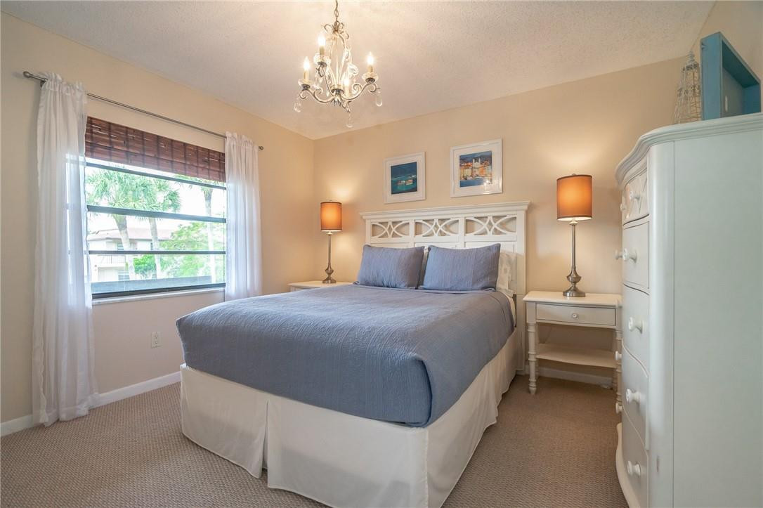 21650 Juego Circle, Unit 24F Boca Raton, FL 33433 - Photo 11 of 24 a bedroom with a bed and window
