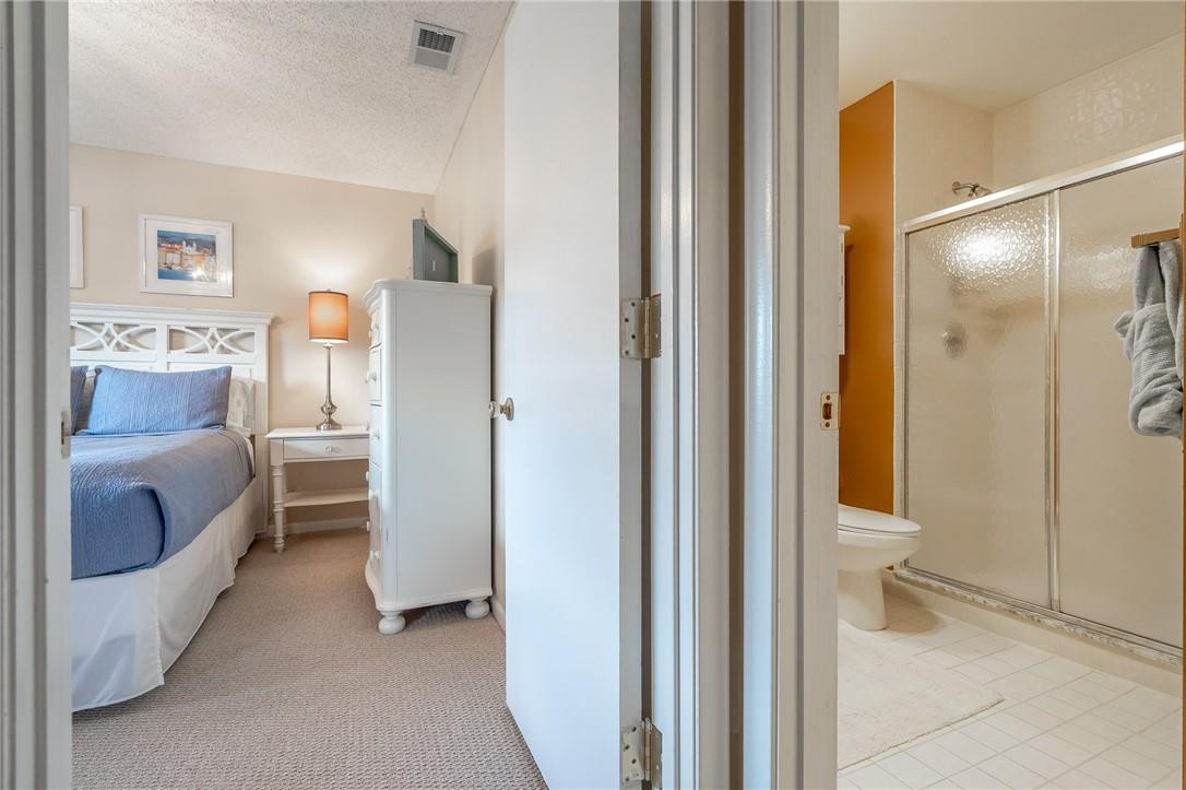 21650 Juego Circle, Unit 24F Boca Raton, FL 33433 - Photo 12 of 24 a en suite bathroom with a toilet sink and shower