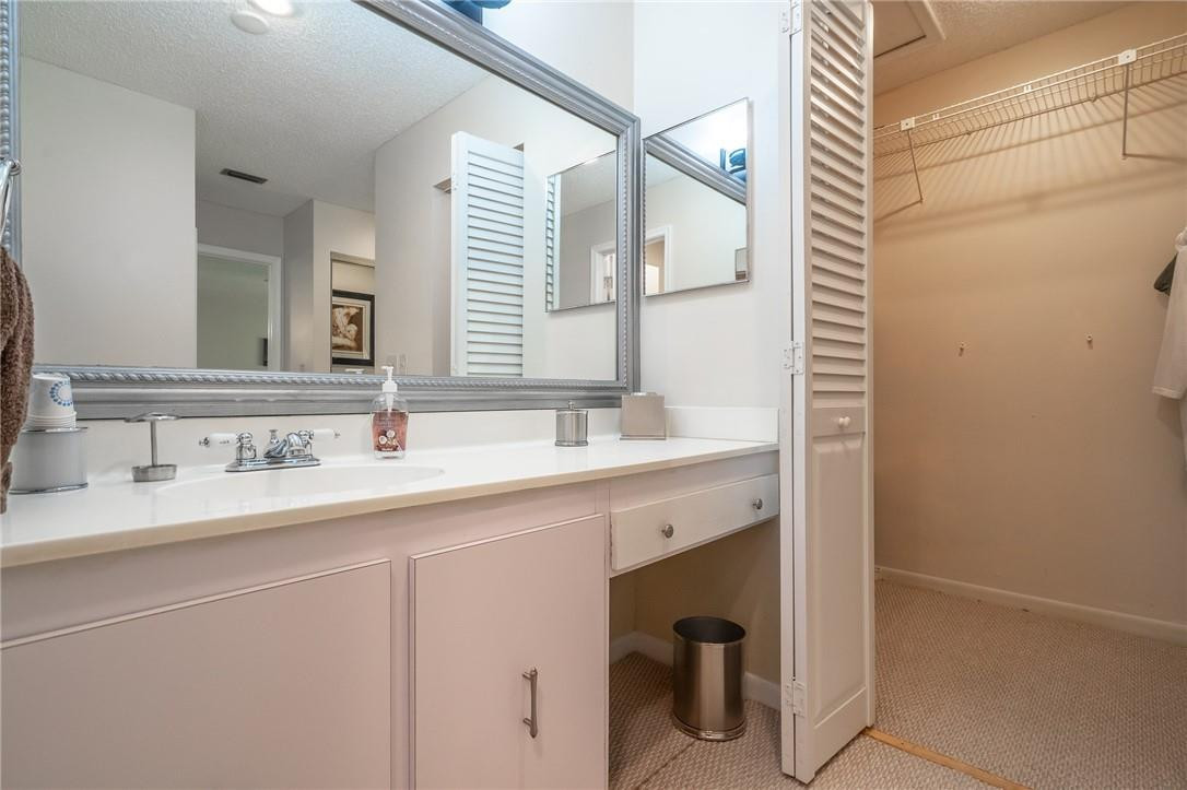 21650 Juego Circle, Unit 24F Boca Raton, FL 33433 - Photo 17 of 24 a bathroom with a sink and a mirror