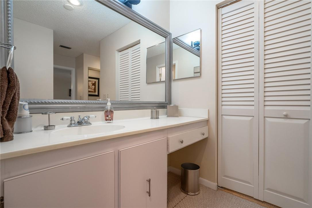 21650 Juego Circle, Unit 24F Boca Raton, FL 33433 - Photo 18 of 24 a bathroom with a sink and a mirror