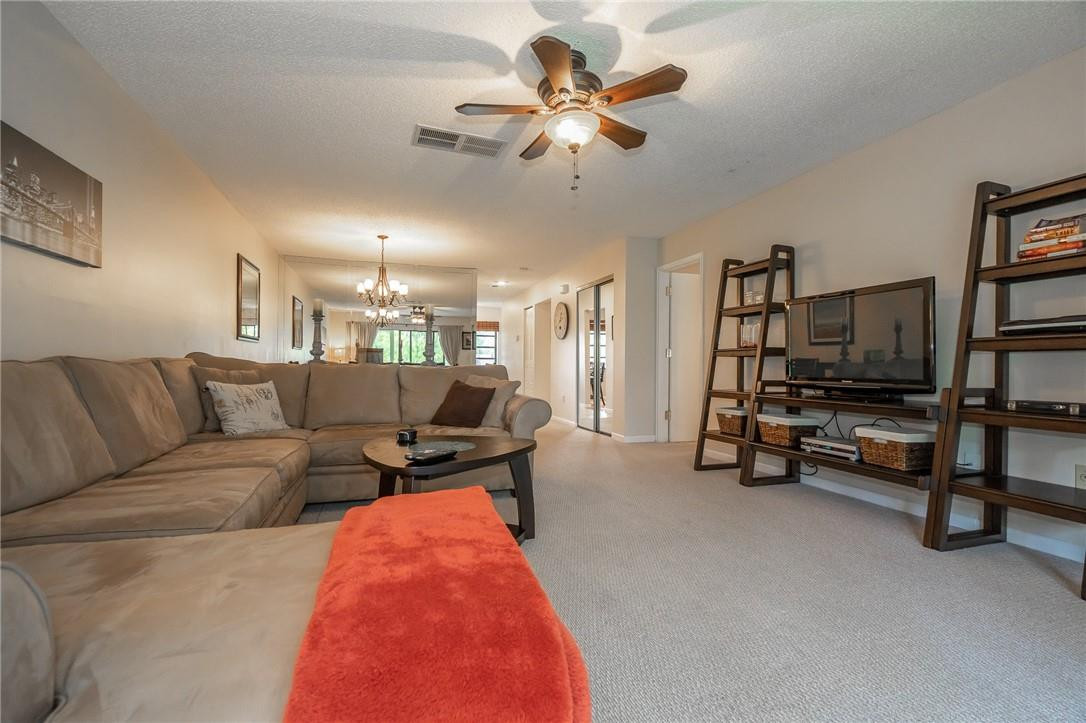 21650 Juego Circle, Unit 24F Boca Raton, FL 33433 - Photo 20 of 24 a living room with furniture and a flat screen tv