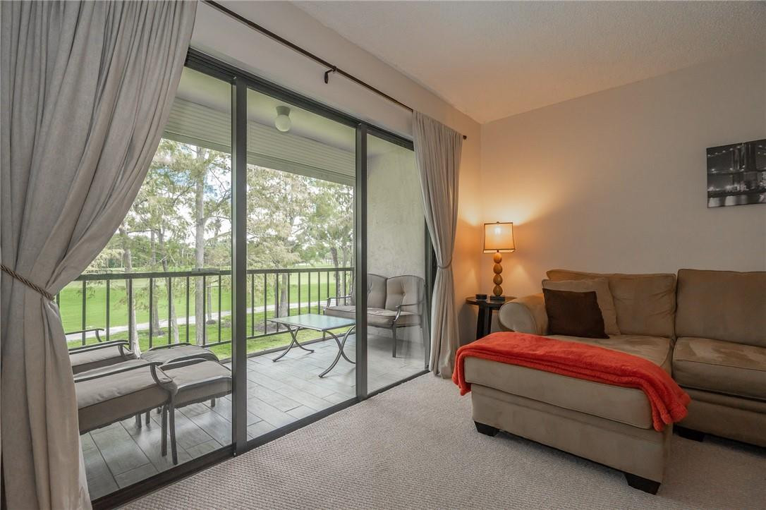 21650 Juego Circle, Unit 24F Boca Raton, FL 33433 - Photo 21 of 24 a bed room with a bed and a couch
