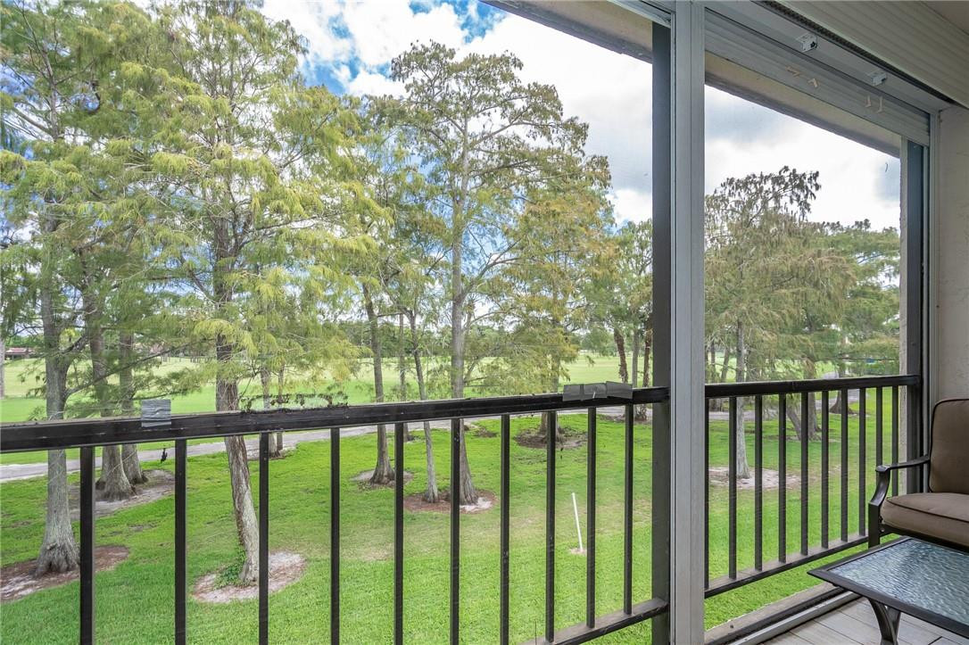 21650 Juego Circle, Unit 24F Boca Raton, FL 33433 - Photo 23 of 24 a view of a balcony with wooden floor