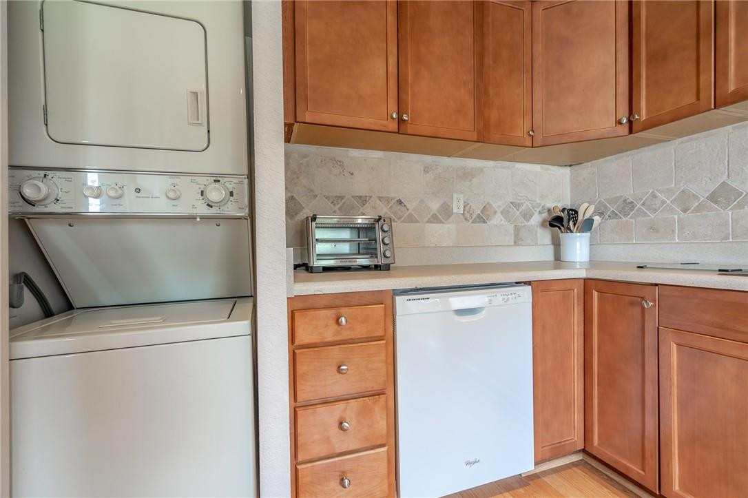 21650 Juego Circle, Unit 24F Boca Raton, FL 33433 - Photo 5 of 24 a kitchen with stainless steel appliances white cabinets and a sink